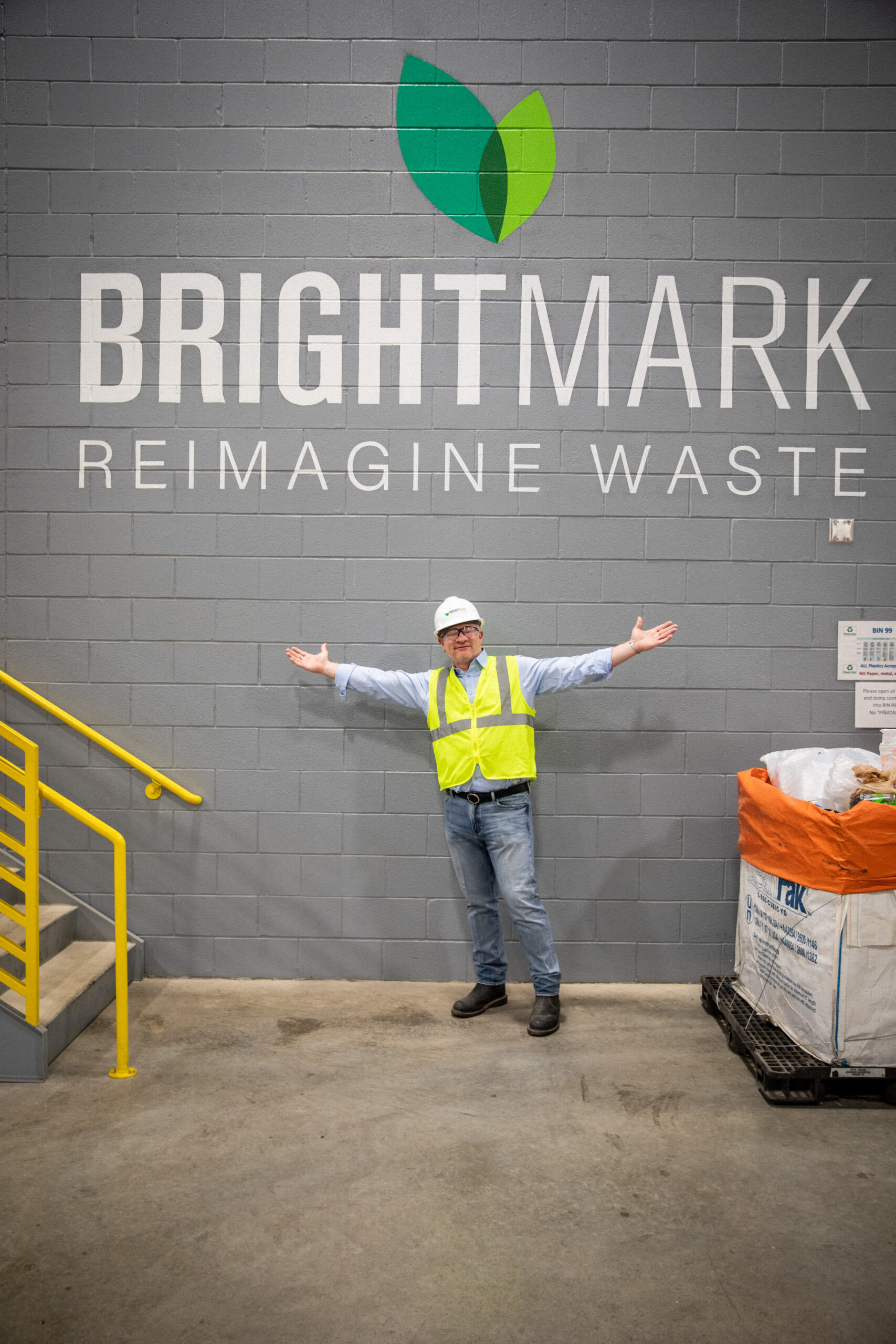 Bob Powell in front of Brightmark sign at plastics facility