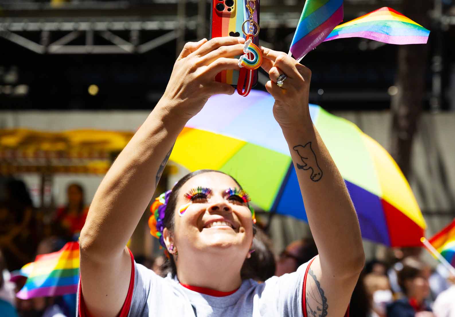 LGBTQ Influencer holding rainbow phone