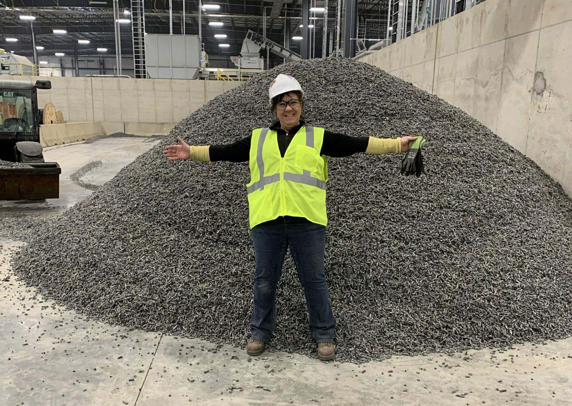 Woman standing in front of pile