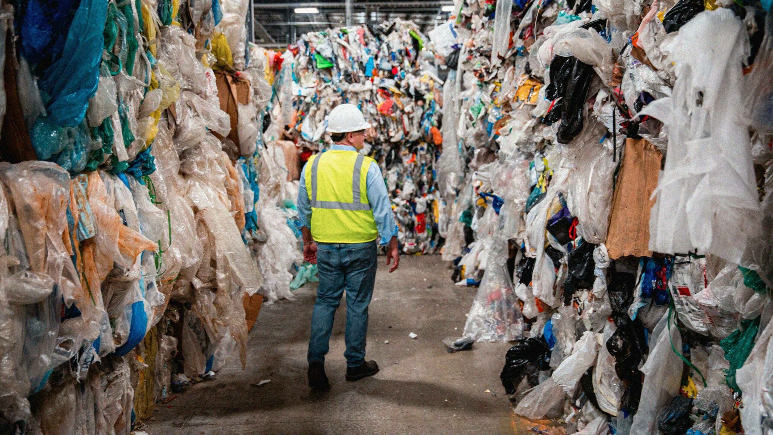 Man walking in plastic recycling center