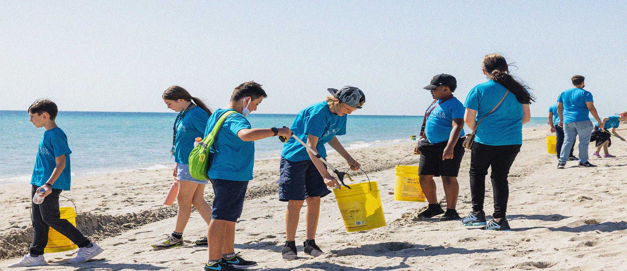 Students cleaning beach