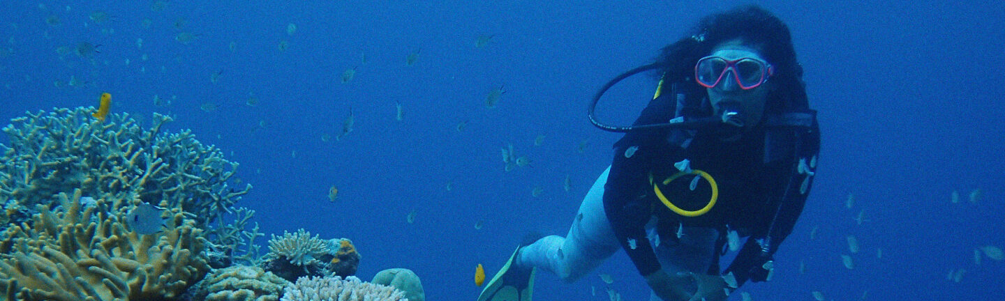 Woman diving in coral reefs