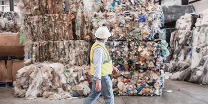 Man walking in recycling facility