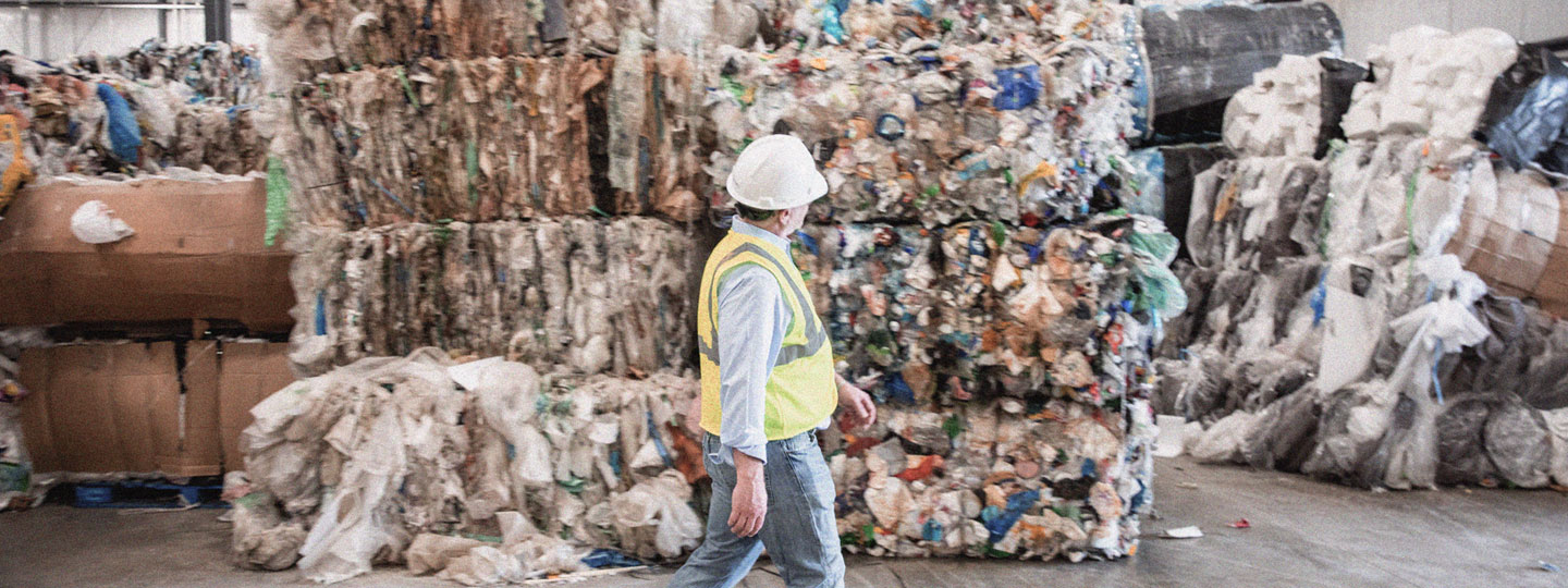 Man walking in recycling facility