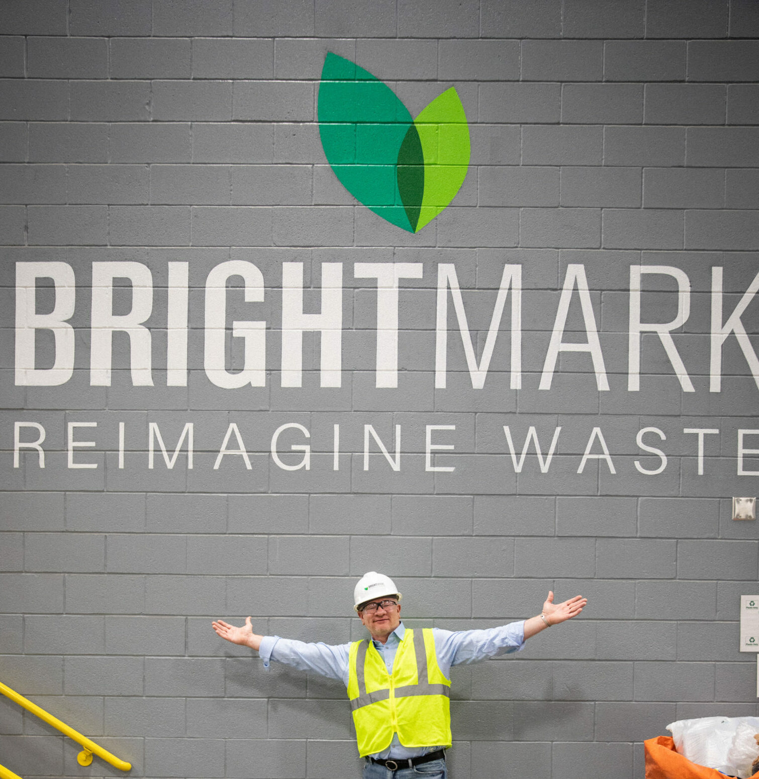 CEO Bob Powell standing in front of the new Brightmark logo painted on the wall