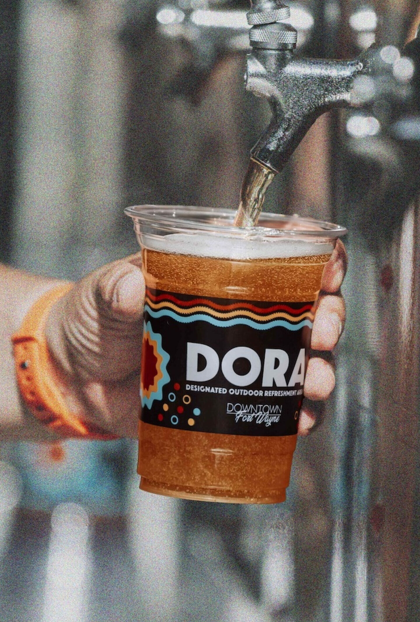 Cup with the Dora logo being filled up.