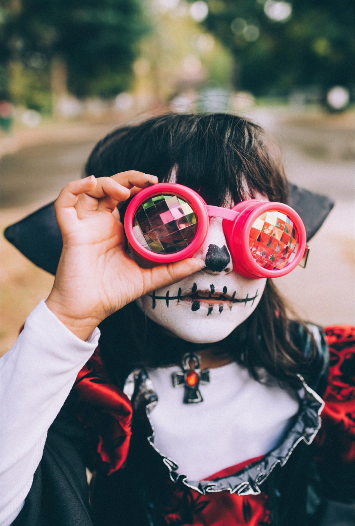 Little Girl in Halloween Costume with Pink Kaleidoscope Glasses